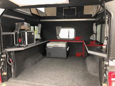 the back end of an rv with its door open and storage area in view,