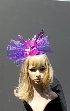 Purple flower surrounded by purple glittered netting, accented with purple artistic feathers and purple jewels.  Step out in style this season werring this lovely flower fascinator headband. Party Tulle Mini Hats, Fitted Tulle Mini Hats For Party, Fitted Tulle Headpieces For Parties, Purple Feathered Headpieces, Purple Feather Headpieces For Spring, Purple Headpiece For Party And Carnival, Purple Headpieces For Party And Carnival, Purple Carnival Headpiece For Party, Whimsical Adjustable Purple Costume Hats And Headpieces