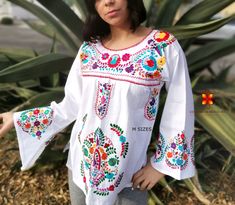 Well designed and well embroidery only for you. Mexican blouse embroidered flowers bell sleeve. This is a blouse embroidered by hand with beautiful colorful flowers. Very comfortable, Goes great with jeans, leggings, skirt, shorts... Each piece is unique and handmade with dedication and taking care of every detail achieving the best quality in our products, which is why it makes it beautiful and unique each of the embroidered flowers. More style, check the following link: https://www.etsy.com/mx Traditional White Embroidered Top For Fall, Traditional White Peasant Top For Fall, Traditional White Blouse For Fall, Long Sleeve Blouse With Multicolor Embroidery And Motif, Long Sleeve Embroidered Top With Motif For Spring, Long Sleeve Embroidered Blouse With Motif, White Blouse With Embroidered Sleeves For Fall, Long Sleeve Top With Multicolor Embroidery And Motif, White Top With Intricate Embroidery For Fall