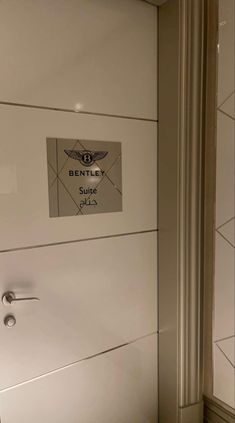 the bathroom door is open and there is a sign on it that says bentley sup