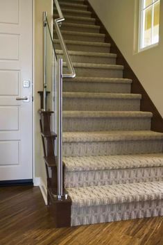 a staircase with carpeted steps leading up to the door