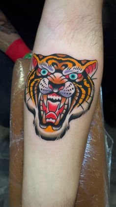 a tiger tattoo on the arm