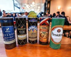 six different types of beer are lined up on a table