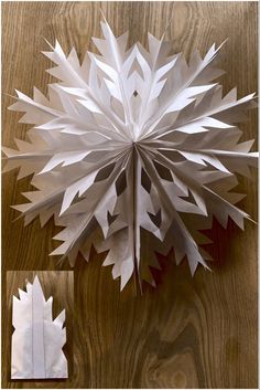 a paper snowflake sitting on top of a wooden table