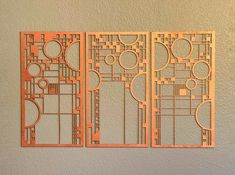 three pieces of laser cut art on a wall