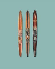 two surfboards sitting next to each other on a blue background, one with an orange stripe