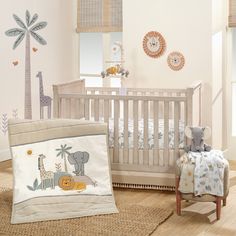 a baby's room with a crib, rocking chair and wall decals