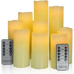 six yellow candles with remote controls in front of them