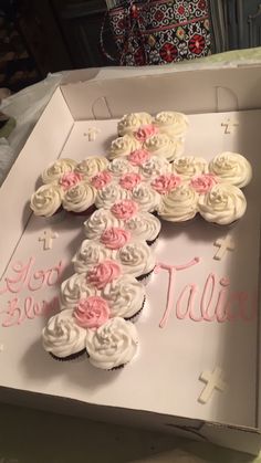 cupcakes are arranged in the shape of a cross on top of a box