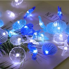 PRICES MAY VARY. 🐟【Handmade Strings light】 Total Length 12.96ft, With 40 Seashell Cold White Led Lights. Every String Is Handmade And Looks Amazing. the copper wire is waterproof and durable, also flexible enough to make various shapes. It is an ideal choice for your various decoration plans. ⭐【8 modes Remote Control and Battery operated】You can put the string light anywhere you want, such as a place there is no plug in around or high and difficult to reach. You can control the light through re Patio Wedding, Beach Themed Bedroom, Outdoor Birthday, Stella Marina, Ocean Decor, Aquarium Decorations, White Led Lights, Ocean Themes, Beach Theme