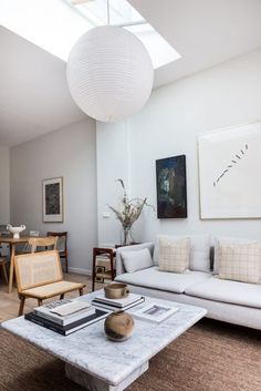 a living room filled with furniture and a skylight