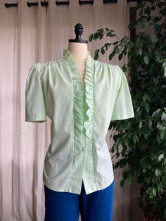 1970's Lime Green Puff Sleeved Ruffled   Blouse. plastic buttons. Made of cotton. Item condition-  this blouse is in fantastic structural condition. no stains or rips. light snagging.  Estimated Size and exact measurements -  Size medium/ large - large  shoulders - 16 across (32) Bust - 23.5 across (47) Waist - 22  across (44) Length -  25 shoulder to hem  Before purchasing. If you would like any more information or photos, please send a message and I would be happy to answer! Item is shipped fully insured with tracking through USPS priority shipping. Item will be shipped with 3 days of purchasing. Retro Cotton Blouse With Puff Sleeves, Vintage Cotton Blouse With Puff Sleeves, Vintage Blouse With Ruffled Collar And Button Closure, Vintage Puff Sleeve Blouse With Buttons, Vintage Ruffled Collar Top For Daywear, Vintage Puff Sleeve Shirt For Spring, Retro Cotton Tops With Ruffles, Vintage Fashion Ruffled Blouse, Vintage Tops With Ruffled Collar And Details