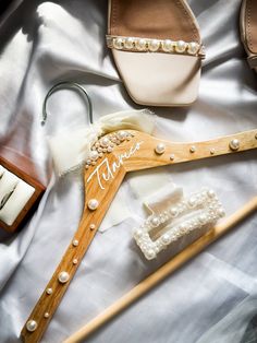 the bride's wedding accessories are laid out on the bed