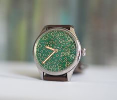 Custom  made watch, Swiss made movement  ETA 6498, custom mechanical wind up watch, Green enameled dial  - movement:mechanical, incabloc 17jewels, manual winding Case material: 316L stainless steel Case size: 44 mm Lug to lug: 52mm Glass : mineral Thickness:12mm Band Width: 22mm See more of our watches: https://www.etsy.com/shop/RetroWatchMZLtd Watch Green, We Watch, Wristwatch Men, Swiss Made, Wrist Watches, Cool Watches, Quartz Watch, Stainless Steel Case, Bulgaria