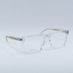 Welcome to OSSA FRAMES, your go-to destination for luxury eyewear! Step into style with the Gucci GG0561ON 005 Shiny Crystal prescription eyeglasses. Crafted by the renowned fashion house Gucci, these designer glasses exude elegance and sophistication. The frame color of Shiny Crystal adds a touch of glamour to your everyday look, while the clear demo lens provides a sleek and modern finish. The square style of these eyeglasses is perfect for women who are looking to make a bold statement with t Gucci Clear Glass Sunglasses, Gucci Clear Square Frame Sunglasses, Classic Gucci Glass Sunglasses, Designer Clear Sunglasses For Formal Occasions, Luxury Clear Square Frame Sunglasses, Gucci Designer Clear Sunglasses, Designer Gucci Clear Sunglasses, Luxury Clear Gucci Sunglasses, Designer Clear Glass Sunglasses