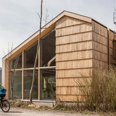 a bike parked in front of a wooden building on the side of a dirt road