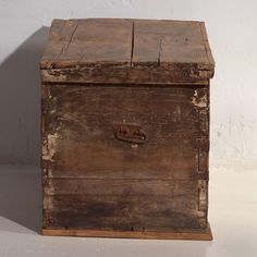 an old wooden box sitting on top of a white floor