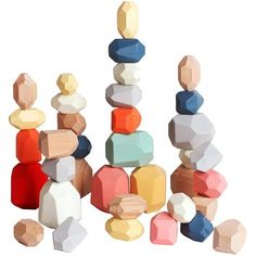 a pile of wooden blocks sitting next to each other on top of a white surface