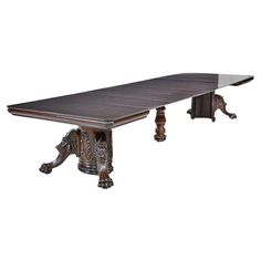 an old style dining table with wooden legs and carvings on the top, against a white background