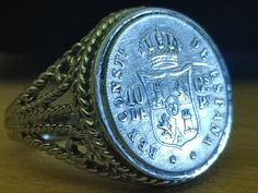 Exquisite 1885 Sterling silver Spanish coin ring genuine coinage starting details mirror bright finish size 8 This silver coin ring is a size 8. It is an original workshop-made band and original coinage with a COA & Box. This handsome authentic original item will also include an attractive certificate of authenticity as well as a high-quality velvet gift box. This ring was made in our Workshop and the coin is from 1885. The band is composed of pure sterling silver. The top of the antique genuine Antique Coin-shape Engraved Signet Ring, Antique Coin Shaped Engraved Signet Ring, Antique Engraved Coin Signet Ring, Antique Silver Signet Ring For Commemoration, Vintage Engraved Coin Signet Ring, Antique Silver Engraved Ring For Commemoration, Silver Coin Ring, Coin Store, Coin Shop