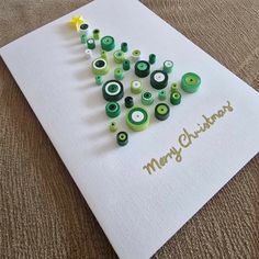 a christmas tree made out of green and white buttons on top of a paper towel