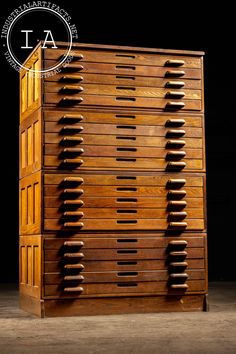 a tall wooden dresser with many drawers on it's sides and the bottom drawer open