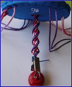 there is a red ball on top of a blue object with a chain attached to it