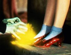 two legs with red shoes and yellow fire