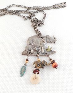 This elephants dangle necklace is a detailed pewter Mother and baby elephant on a plain with 3 dangles of wood, and metal with another elephant too. is a nice sturdy piece which does not bend the pendant with dangles measures 1 3/4 by 2 1/4 and hangs on a pewter chain which measures 28 inches is in excellent condition I have no pets or smokers in my home. If you love vintage necklaces, be sure to check out others I have listed! www.etsy.com/shop/SultanaVintageJewels?ref=hdr_shop_menu§ion_id=1521 Mother And Baby Elephant, Dangle Necklace, Vintage Pewter, Vintage Necklaces, Dangle Necklaces, African Elephant, Mother And Baby, Baby Elephant, Necklace Gift