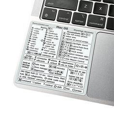 a computer keyboard with stickers on it's keys and some words written in different languages