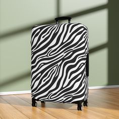 Luggage is expensive, and they aren't always treated with care.  So why not protect your investment with our wild black and white zebra luggage cover!  Our cover not only adds a touch of wild flair to your bags but prolongs the life of your suitcase by shielding them from scratches, scuffs, and unexpected travel mishaps. You will have no trouble spotting this trendy zebra-inspired luggage cover at the baggage carousel!  Makes a wonderful gift for travel-loving friends or family. But it's not all about looks; its about substance too!  Crafted from durable, very stretchy high-quality material, our unique luggage cover is designed to securely fit most standard suitcase sizes.  Plus, its quick and easy to install and remove by way of a top opening for the pull handle, an opening on the left fo Black Cases With Luggage Sleeve For Trip, Black Rectangular Cases For Overnight Trips, Black Travel Cases With Luggage Sleeve, White Suitcase, Unique Luggage, Honeymoon Clothes, Baggage Carousel, Suitcase Sizes, Honeymoon Outfits