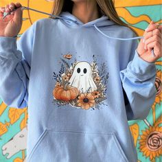 All Stickers and Purchases above $35 are eligible for free shipping  Welcome to Wild&WanderLyss! Our "Cute Ghost and Pumpkin" hoodie is perfect for those who want a cozy, cute, and spooky look for the fall season. ✧✦ PRODUCT DETAILS ✦✧      ✦ Premium quality super soft hoodie.      ✦ All hoodies are unisex. (Please check listings for detailed size charts.)           ✧ 100% ring-spun cotton           ✧ Light fabric           ✧ Eurofit           ✧ Tear-away label           ✧ Runs true to size  How Do I Order       ❶ Please review all the information provided before placing your order.      ❷ Select the item type and size using the drop-down menu.      ❸ Select the color of the hoodie using the following drop-down menu.      ❹ Need more items? Add the current item to the cart and press the ba Blue Hooded Halloween Hoodie, Blue Halloween Hoodie, Blue Long Sleeve Hoodie For Halloween, Fall Cartoon Print Hooded Hoodie, Fall Hoodie With Cartoon Print, Spooky Long Sleeve Sweatshirt For Winter, Cotton Hoodie With Character Print For Fall, Blue Long Sleeve Hoodie With Character Print, Casual Hooded Halloween Sweatshirt