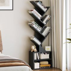 a bedroom with a bed, bookshelf and pictures on the wall above it