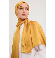 Shine Hijab Shawl - Gold Glossy in texture and elegant in appearance, our shine shawl is set to be the next great addition to your wardrobe! Its sleek shine makes for an impressive final touch to formal wear so you could look and feel your best on any special occasion. FEATURES: - Glossy finish - Suitable for all seasons - Opaque (not transparent) MATERIAL: - 75 cm x 185 cm - Polyester CARE: - Hand wash separately in cold water. - Lay flat to dry. - Iron on low without steam. Made in Turkey Elegant Shawl For Eid And Formal Occasions, Elegant Shawl For Formal Eid Occasions, Elegant Formal Shawl For Eid, Elegant Scarves For Eid Festival, Elegant Festive Scarves For Eid, Gold Shawl For Formal Festive Occasions, Formal Festive Gold Shawl, Elegant Scarves For Formal Festive Occasion, Elegant Formal Scarf For Festive Occasions