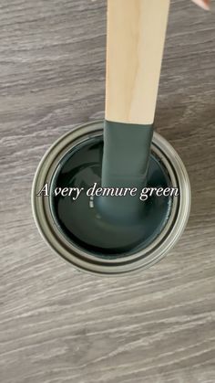 a person is painting a wooden floor with green paint and the words every demure green on it