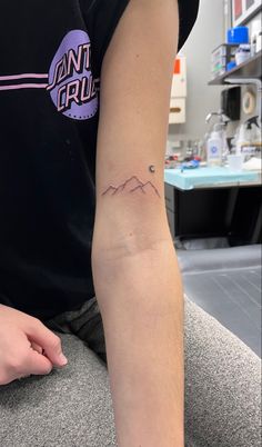 a person with a small tattoo on their arm