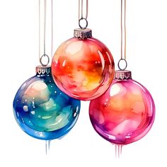 three christmas ornaments hanging from strings with watercolor paint on the bottom one ornament