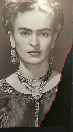 an old black and white photo of a woman with jewelry on her neck, looking at the camera