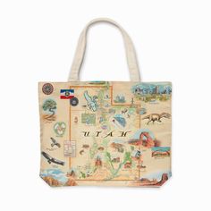 A large canvas tote bag with an intricate map of Utah, featuring highlights like Salt Lake City, Moab's Arches National Park, Bryce Canyon, Capitol Reef, Zion National Park, Dinosaur National Monument, and scenic landscapes depicting the state's diverse flora and fauna. Utah Map, Map Tote Bag, Flathead Lake, Realtor Closing Gifts, Map Canvas, Wood Puzzles, Utah National Parks, Smoky Mountain National Park, Wedding Gift Favors