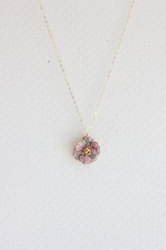 "Description This sweet little pendant necklace features a rare vintage enamel pink confetti pansy flower trimmed with a gold finish. . Great gift for the flower lover in your life or treat yourself to a lovely pansy pendant Hangs from a fine 14 karat gold filled chain. The Pansy is 1 \" wide, vintage elements are in excellent condition. ** The last photo shows a different pansy with the soaring bird charm, this pansy is the same size as the pink one Spring closure clasp Photoed with a 16\" chai Pink Gold Flower Jewelry For Gifts, Vintage Pink Gold Jewelry For Gift, Delicate Enamel Jewelry For Gifts, Cute Gold Jewelry With Flower Charm, Delicate Enamel Jewelry Gift, Dainty Pink Gold Flower Jewelry, Pink Flower Charm Jewelry As Gift For Mom, Vintage Pink Gold Jewelry As Gift, Pink Flower Charm Jewelry Gift For Mom