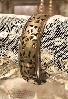 "Intricate Metalwork~Filigree Bangle Bracelet ~Vintage well made Silver over Brass Bangle Bracelet 2 layers of metal , filigree or pierced design layer over a solid layer Approximately 3/4\" wide Approximately 2 5/8\" opening ... I imagine this used to be more silver and has wore to silver with lots of brass showing through... I love the look ! pretty & different! This could be polished if you desire a bright shiny mixed metal look.. The patina on this piece really adds to its appeal to me ... s Victorian Brass Silver Bracelets, Brass Filigree Bracelets For Gifts, Victorian Metal Bangle Bracelet, Brass Filigree Bracelets As Gift, Victorian Style Metal Bangle Bracelet, Vintage Metal Cuff Bracelet With Filigree, Ornate Metal Bangle For Gift, Elegant Engraved Bangle For Festival, Metal Filigree Cuff Bracelet Gift