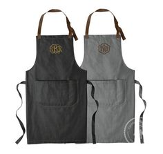 two aprons with monogrammed initials on the front and back, one in grey