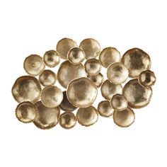 a bunch of gold colored shells on a white background