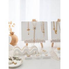 there are many necklaces on display in the room with white walls and flooring