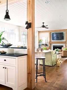 an open concept kitchen and living room with wood flooring