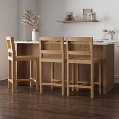 three wooden chairs sitting next to each other on top of a hard wood floored kitchen