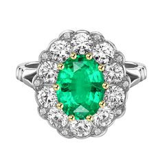 an emerald and diamond cluster ring