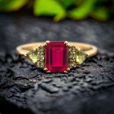 Ruby Engagement Ring, 14K Yellow Gold Proposal Ring, Peridot Cluster Wedding Jewelry, Emerald Cut Promise Ring, Anniversary Gift For Wife   Main Stone- Ruby (Lab Created) Stone Shape: Emerald  Stone Color: Pink Stone Size:   8x6 mm Second Stone:- Peridot (Lab Created) Stone Cut:- Trilliant /Round Stone Color:- Green  -------------------------------------------------------------------------------------------------------------------------------------------------------------- Customized Design: For custom making jewelry, it can be made in 2 different metals 1. Solid gold, including 14/18k white/yellow gold. 2. 925 sterling silver with white/yellow/rose gold plated. we can change stone and design according to your choice but price will be change. Standard Delivery : The delivery time usually t Ruby And Peridot Ring, Wedding Ring With Emerald Cut Peridot, Peridot Birthstone Ring For Wedding, Green Three Stone Birthstone Ring For Wedding, Peridot Birthstone Ring With Center Stone For Wedding, Wedding Rings With Peridot And Accent Stones, Emerald Cut Multi-stone Ruby Ring For Wedding, Multi-stone 14k Gold Ruby Ring For Wedding, May Birthstone Wedding Ring With Three Stones