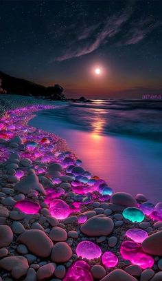 the beach is covered in glowing rocks and pebbles