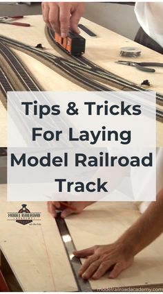 a person working on a model railroad track with the words tips & tricks for laying model railroad tracks